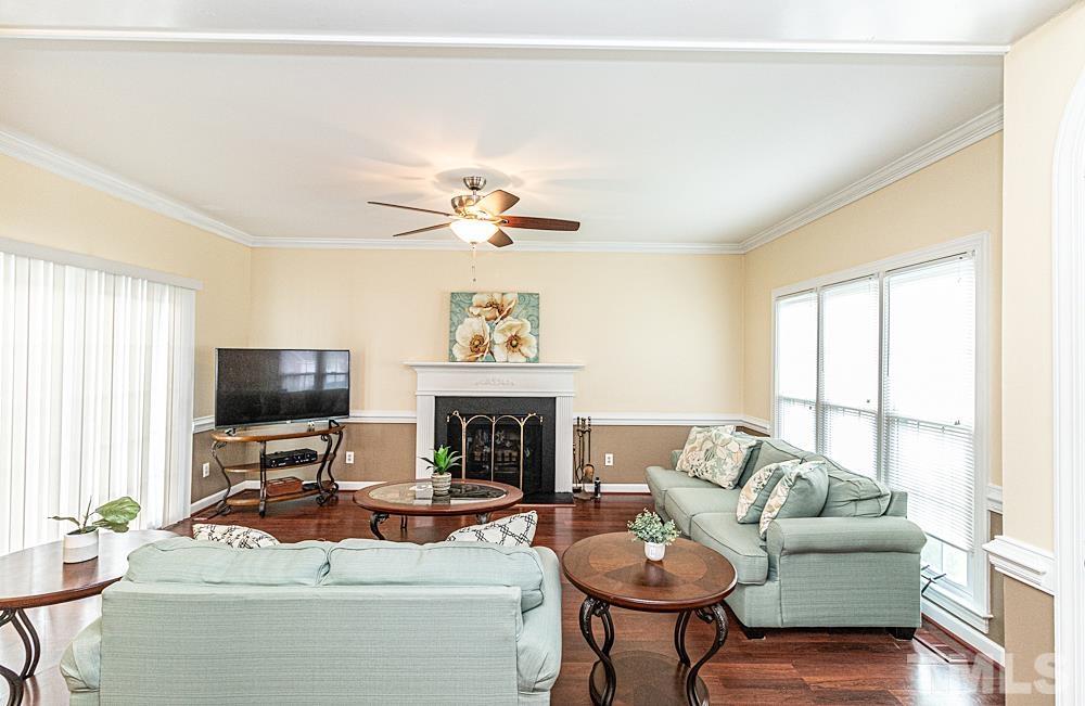 1875 Forest Wood Road Rocky Mount, NC 27804 - Photo 3 of 17 a living room with furniture a fireplace and a flat screen tv