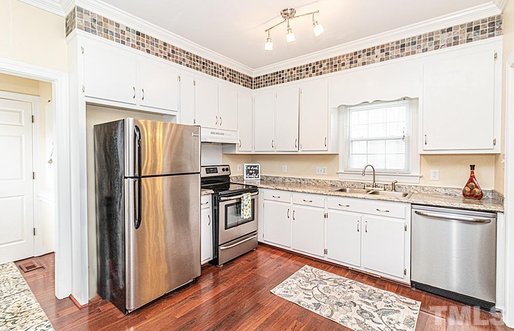 1875 Forest Wood Road Rocky Mount, NC 27804 - Photo 5 of 17 a kitchen with granite countertop a sink stainless steel appliances and cabinets