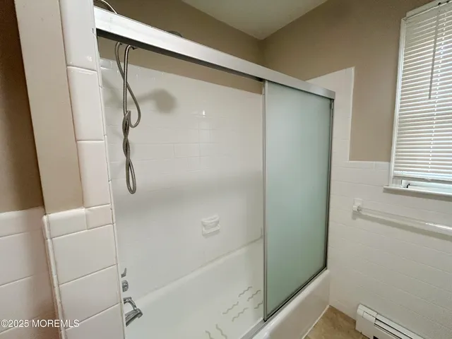 a bathroom with a shower and a toilet