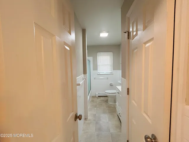 a bathroom with a shower and a toilet
