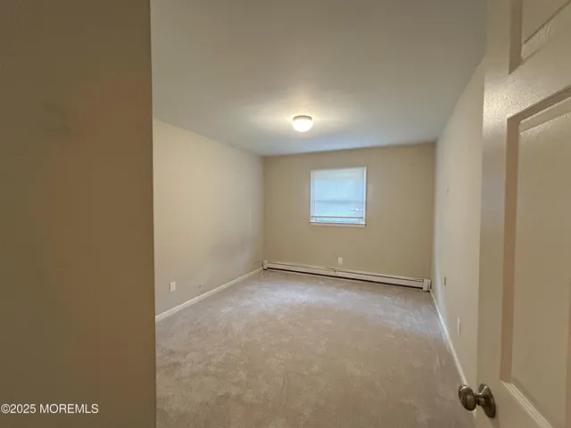 a view of an empty room and a window