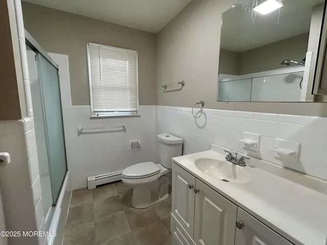 a bathroom with a sink toilet and mirror