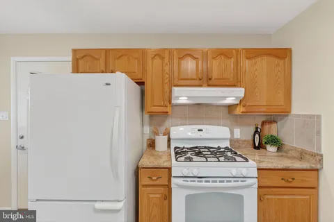 a kitchen with a stove and a refrigerator