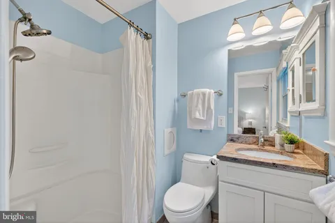 a bathroom with a toilet a sink and a mirror