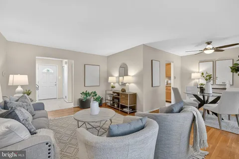 a living room with furniture and a wooden floor