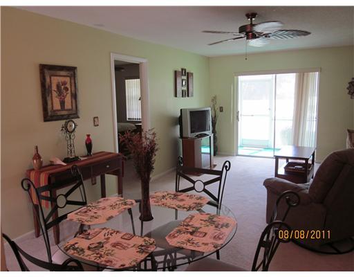 1979 Southwest Palm City Road, Unit 41B Stuart, FL 34994 - Photo 13 of 14 a living room with furniture and a window