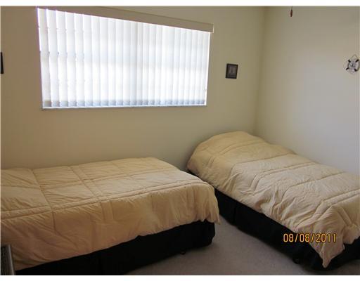 1979 Southwest Palm City Road, Unit 41B Stuart, FL 34994 - Photo 14 of 14 a bedroom with two beds and a window