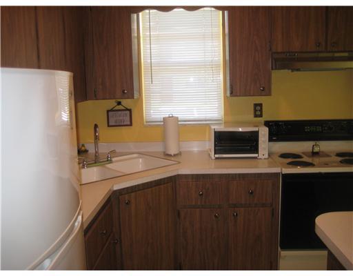 1979 Southwest Palm City Road, Unit 41B Stuart, FL 34994 - Photo 6 of 14 a kitchen with a sink a window and cabinets
