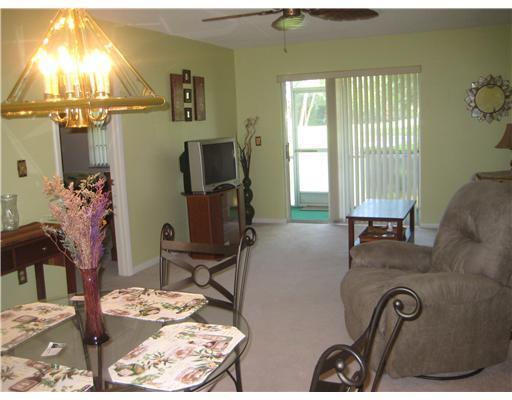 1979 Southwest Palm City Road, Unit 41B Stuart, FL 34994 - Photo 7 of 14 a living room with furniture and a flat screen tv
