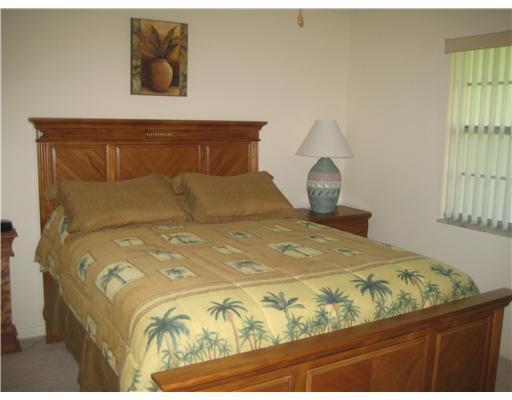 1979 Southwest Palm City Road, Unit 41B Stuart, FL 34994 - Photo 9 of 14 a bedroom with a bed and window
