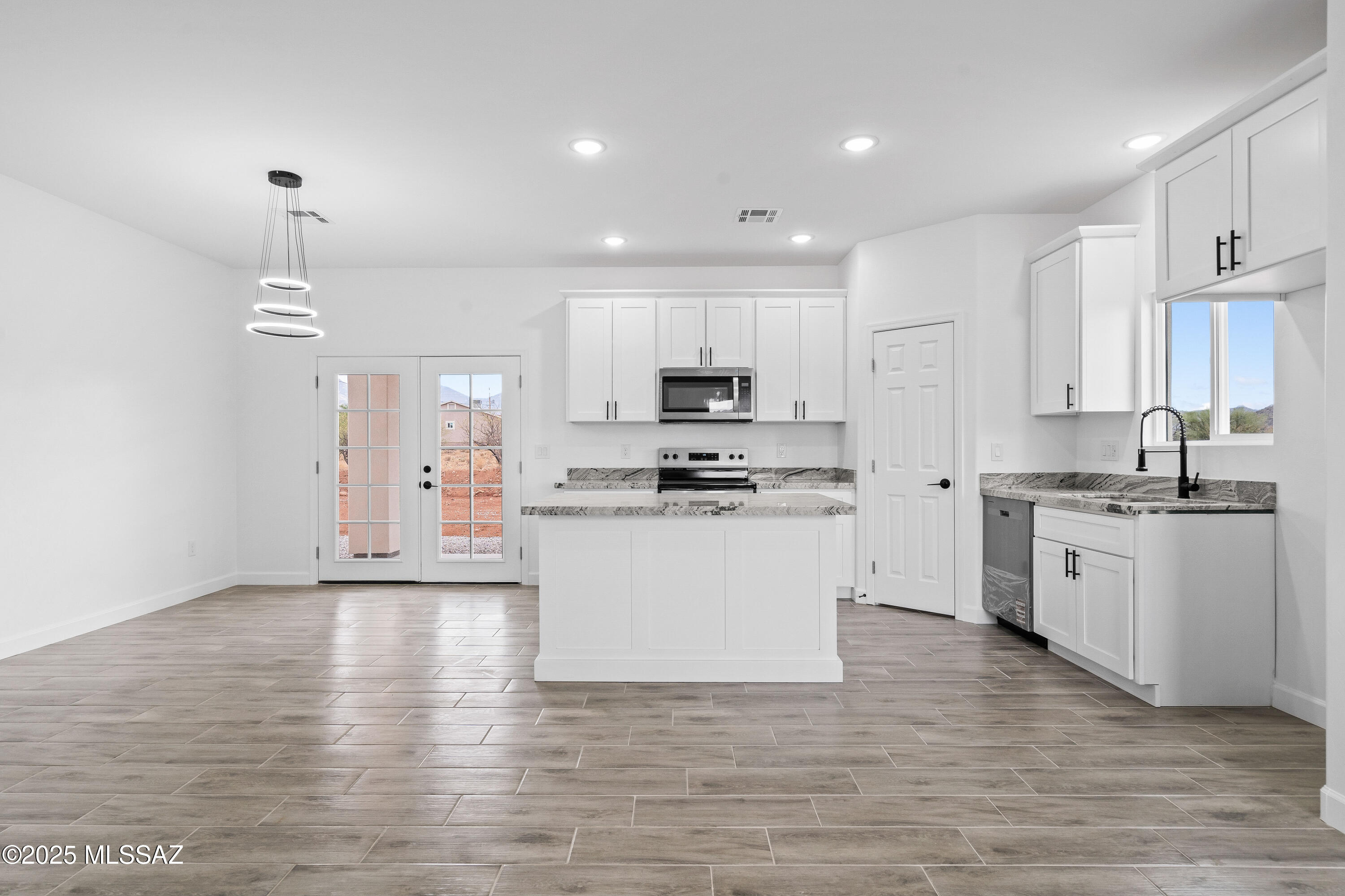 1851 Calle Salmon Rio Rico, AZ 85648 - Photo 11 of 29 a kitchen with granite countertop white cabinets and white appliances