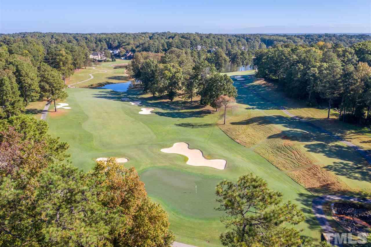 6908 Tanbark Way Raleigh, NC 27615 - Photo 1 of 10 a view of a lake in middle of forest