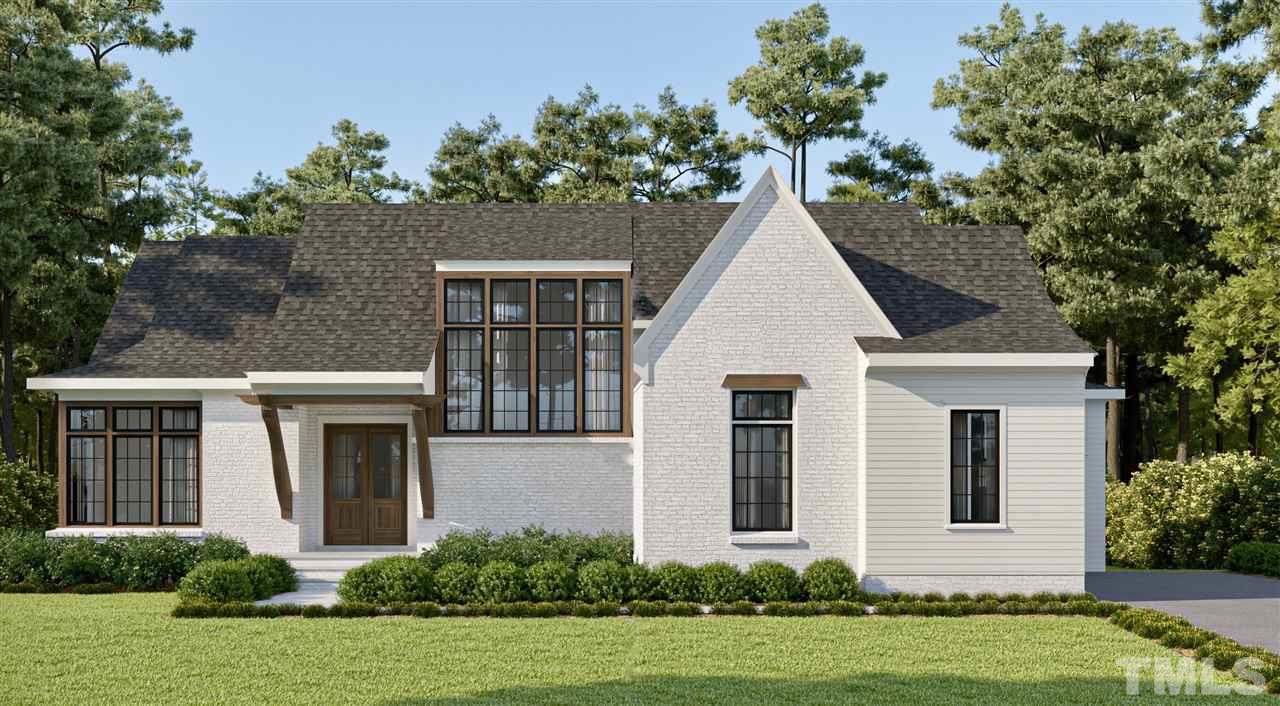 6908 Tanbark Way Raleigh, NC 27615 - Photo 2 of 10 a view of a white house with a yard and potted plants