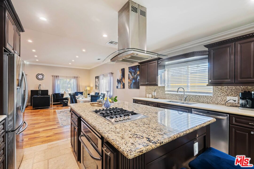 5181 Densmore Avenue Encino, CA 91436 - Photo 12 of 73 a kitchen with granite countertop a sink stove and cabinets