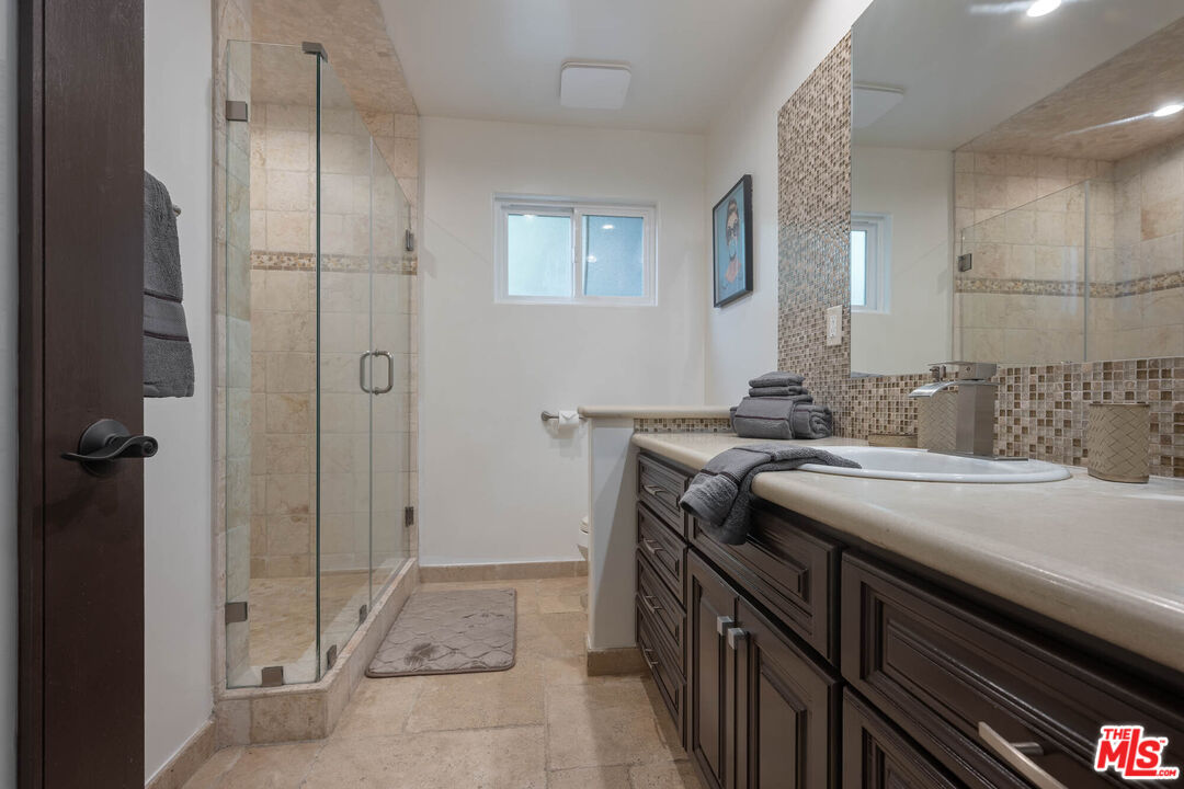 5181 Densmore Avenue Encino, CA 91436 - Photo 17 of 73 a bathroom with a sink and a mirror