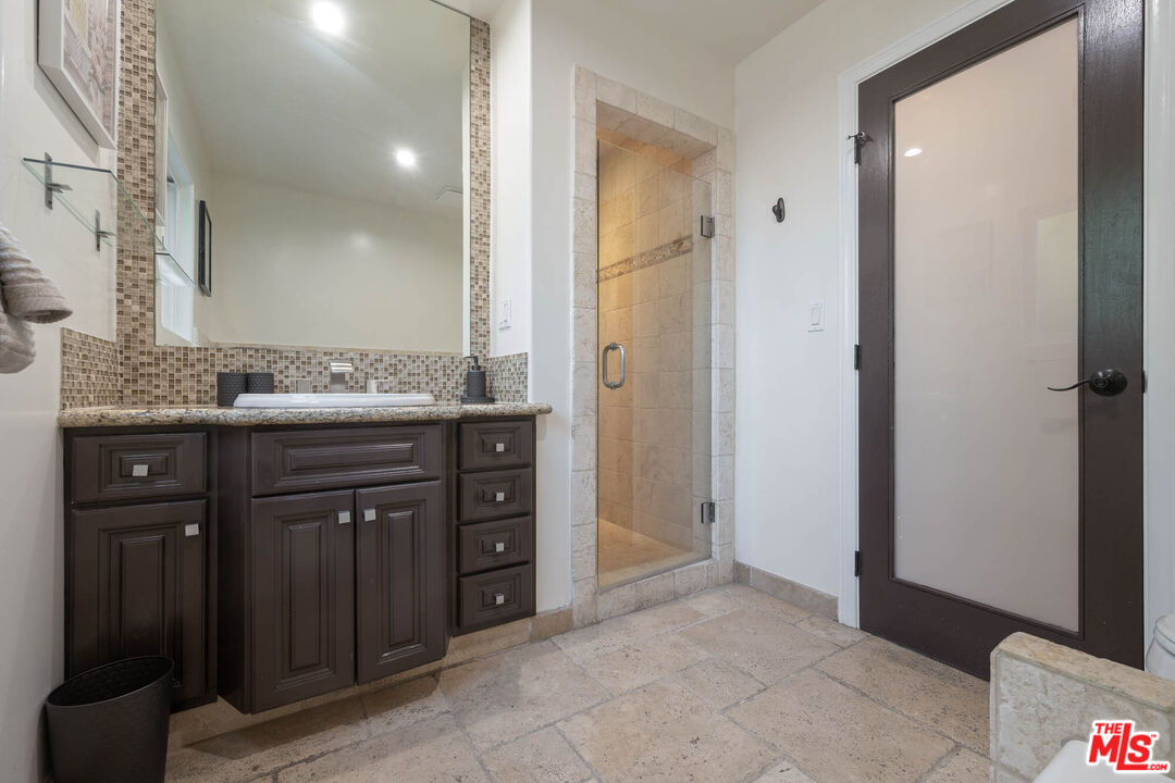 5181 Densmore Avenue Encino, CA 91436 - Photo 20 of 73 a bathroom with a granite countertop sink and a mirror
