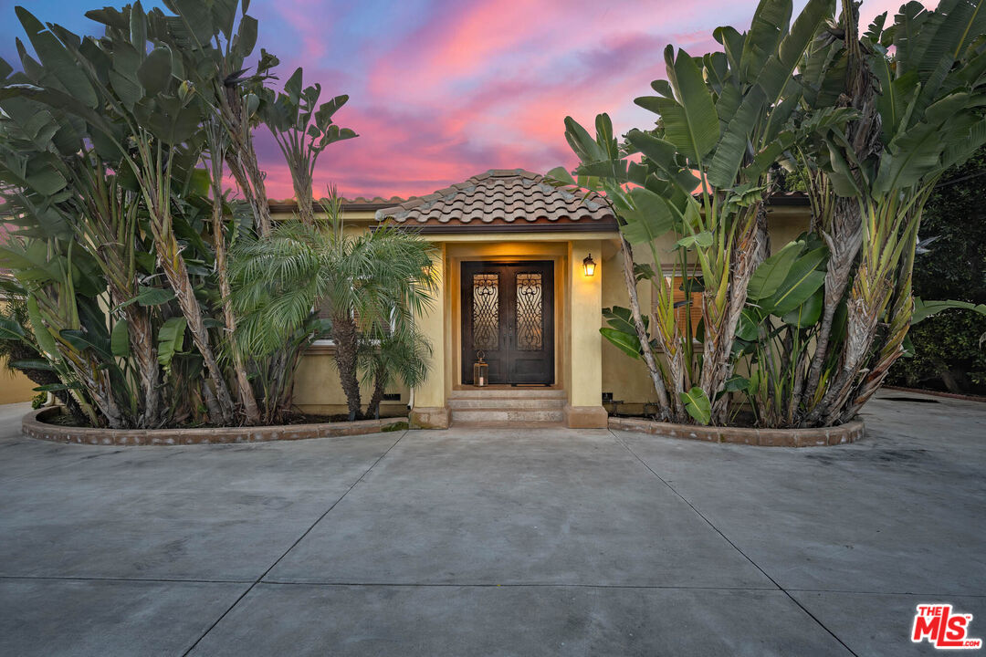 5181 Densmore Avenue Encino, CA 91436 - Photo 29 of 73 a front view of a house with a garden