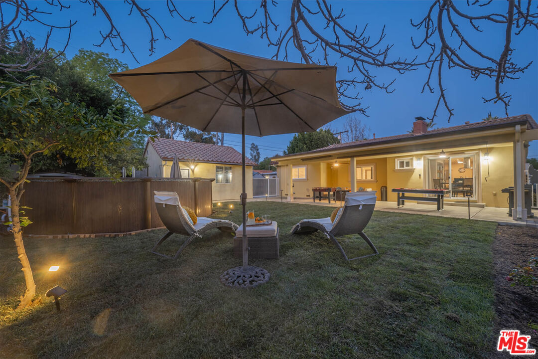 5181 Densmore Avenue Encino, CA 91436 - Photo 32 of 73 a view of an outdoor sitting area with couch and umbrella