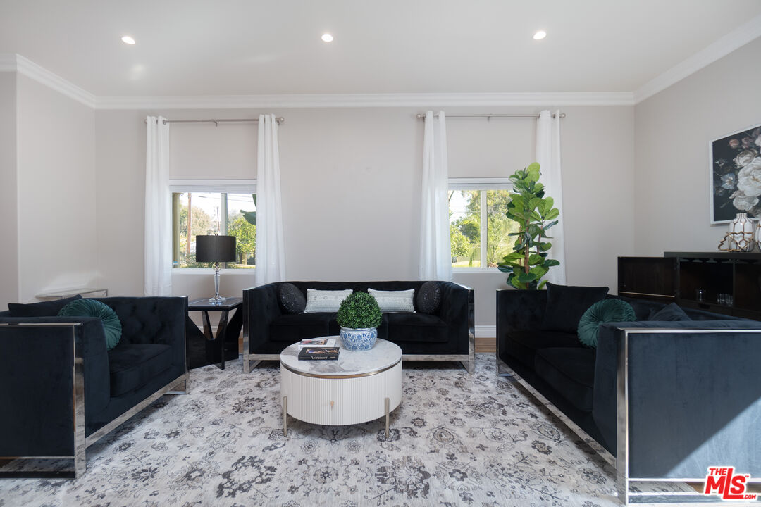 5181 Densmore Avenue Encino, CA 91436 - Photo 33 of 73 a living room with furniture and a potted plant