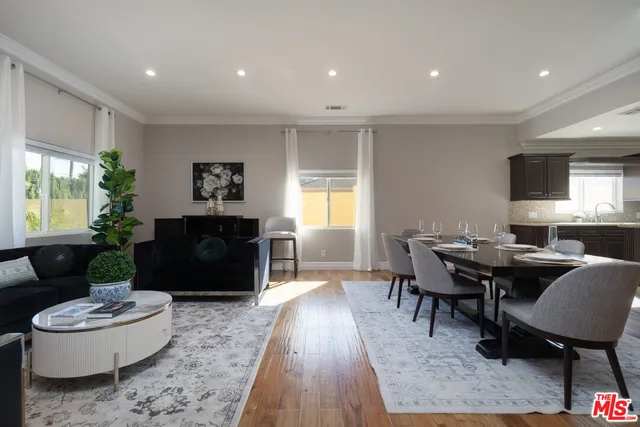 a kitchen with stainless steel appliances granite countertop a refrigerator a sink a stove a microwave and cabinets