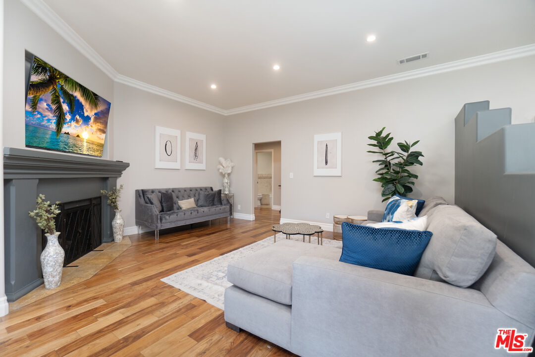 5181 Densmore Avenue Encino, CA 91436 - Photo 36 of 73 a living room with furniture and a fireplace
