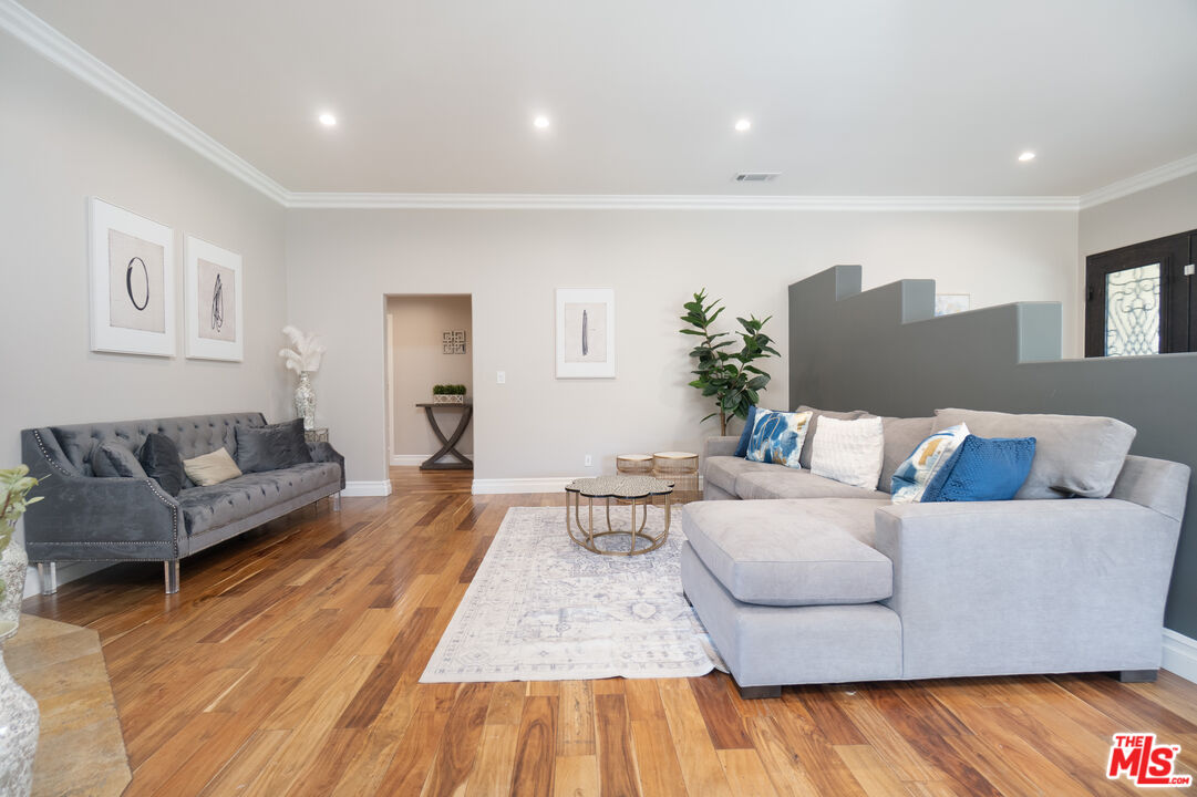 5181 Densmore Avenue Encino, CA 91436 - Photo 37 of 73 a living room with furniture and wooden floor