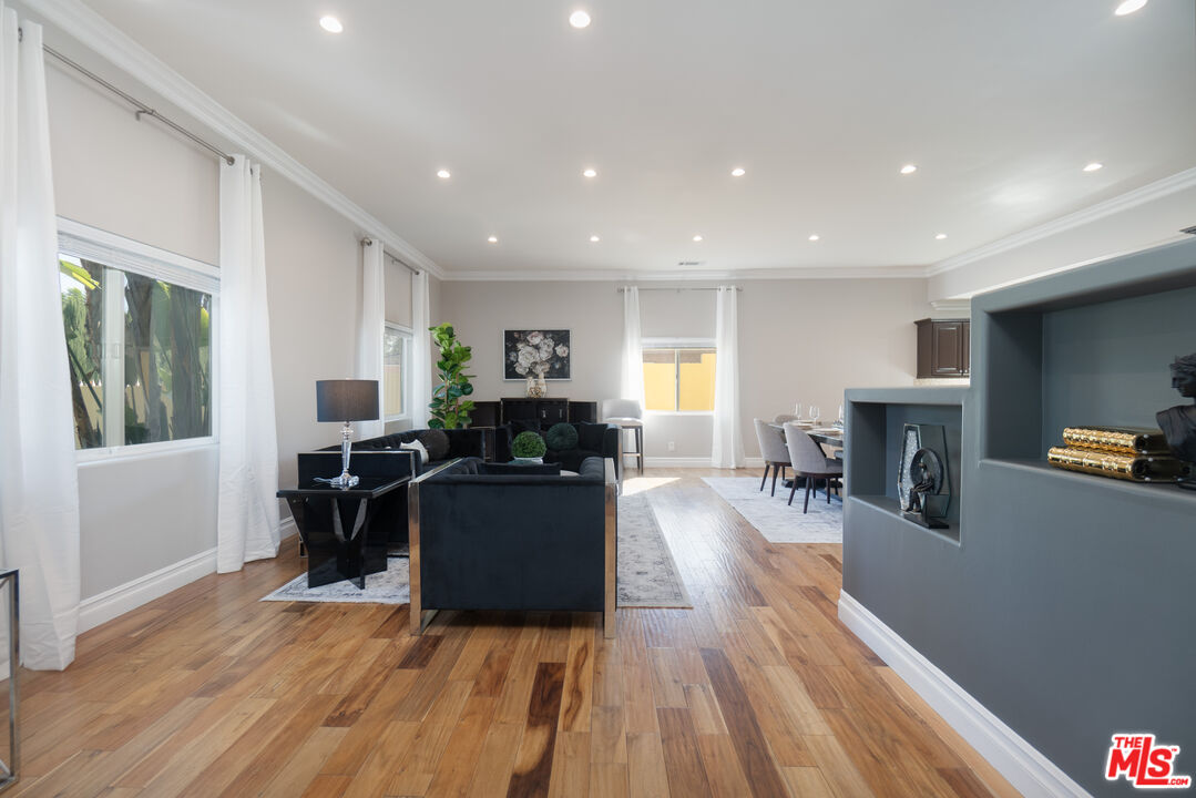 5181 Densmore Avenue Encino, CA 91436 - Photo 38 of 73 a living room with furniture a fireplace and a wooden floor