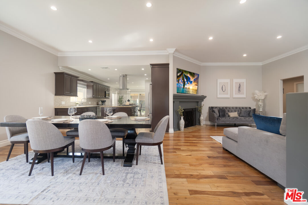 5181 Densmore Avenue Encino, CA 91436 - Photo 39 of 73 a living room with fireplace furniture and a wooden floor