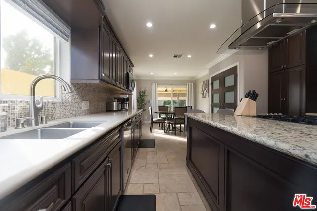 a bathroom with a granite countertop toilet a sink and bathtub