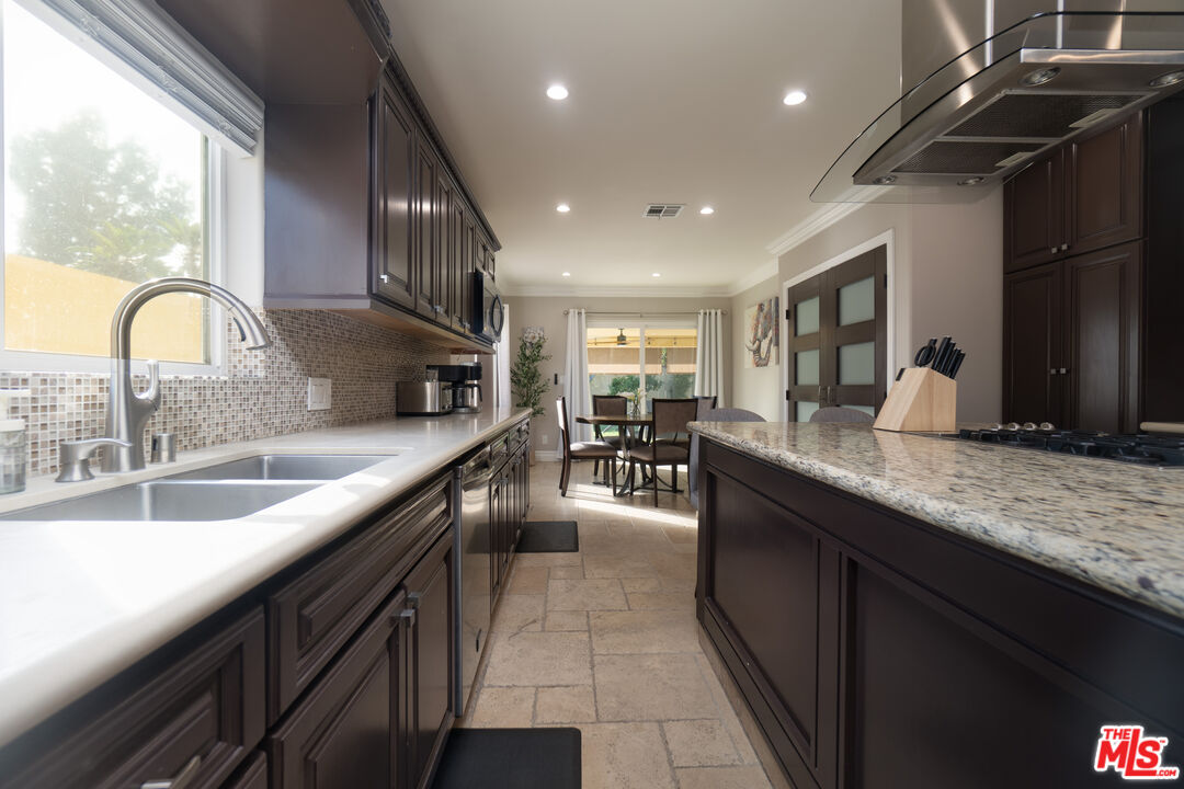 5181 Densmore Avenue Encino, CA 91436 - Photo 46 of 73 a kitchen with counter top a sink and cabinets