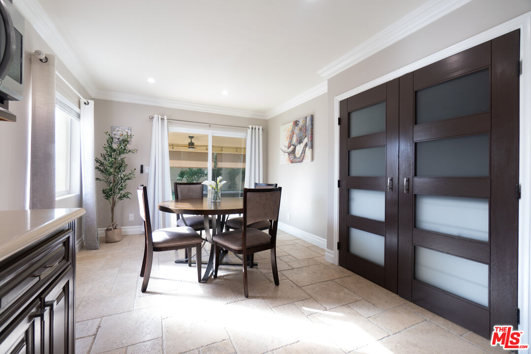 5181 Densmore Avenue Encino, CA 91436 - Photo 47 of 73 a dining room with furniture and front door view