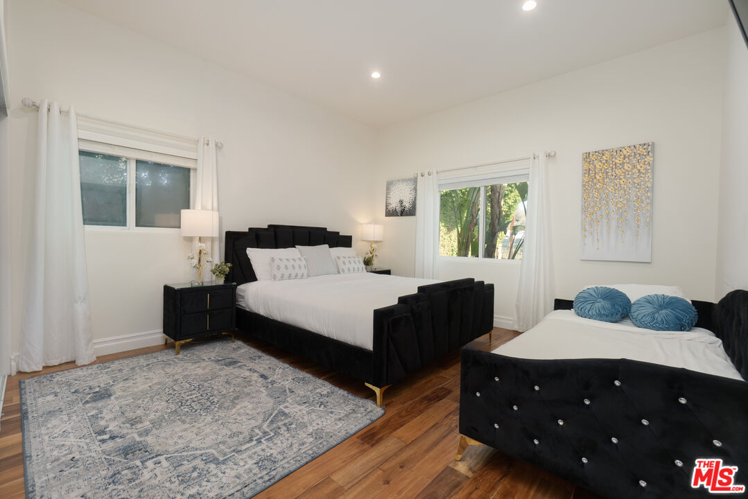 5181 Densmore Avenue Encino, CA 91436 - Photo 50 of 73 a bedroom with a bed and wooden floor