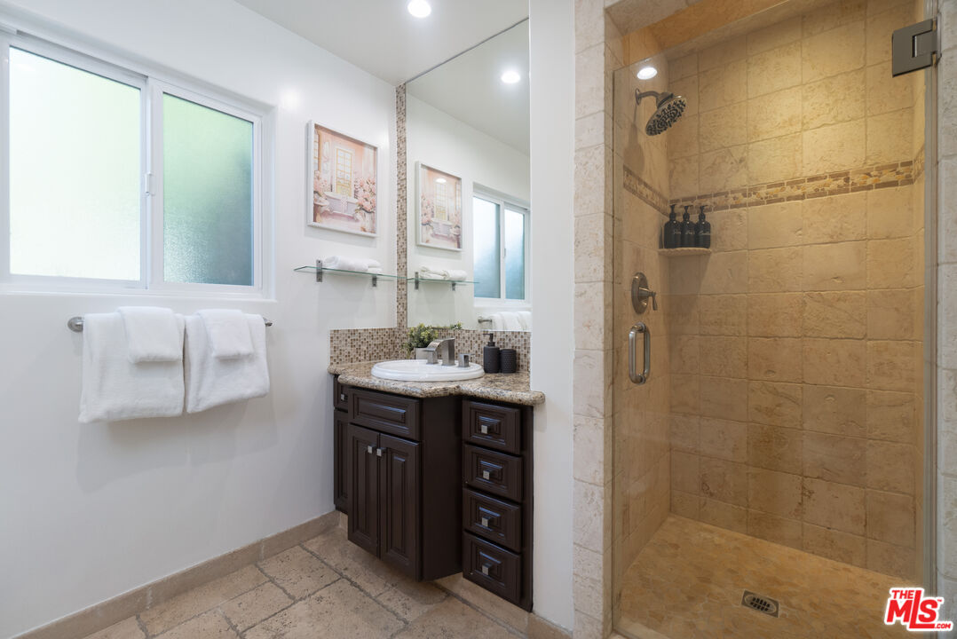 5181 Densmore Avenue Encino, CA 91436 - Photo 53 of 73 a spacious bathroom with a granite countertop sink a toilet and shower