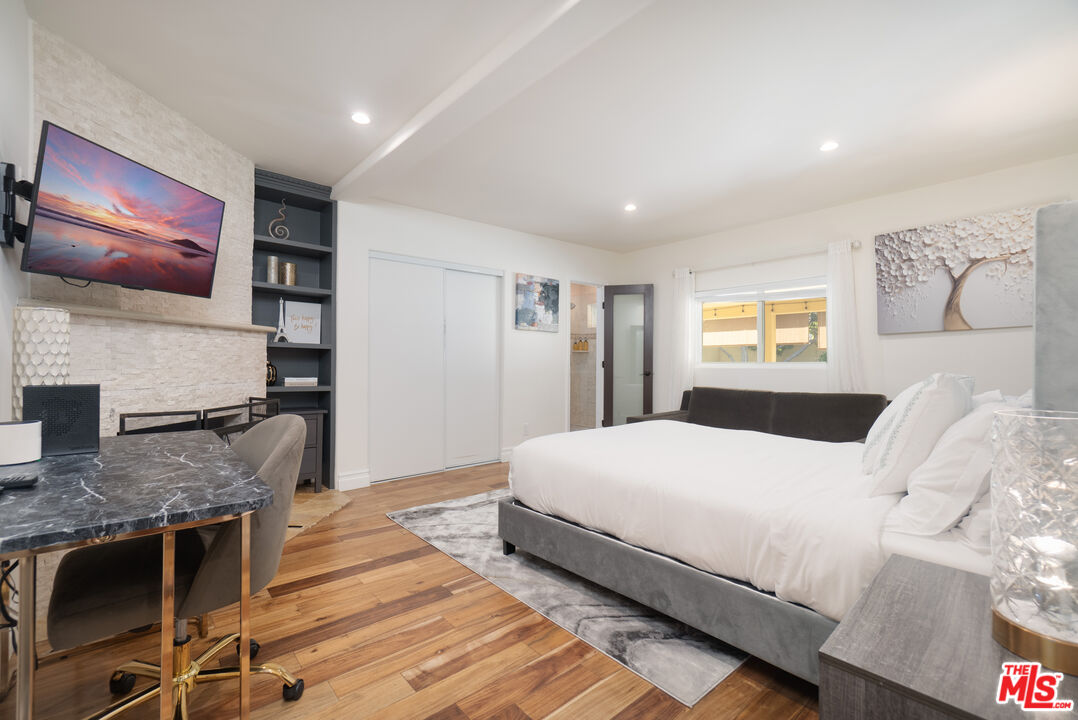 5181 Densmore Avenue Encino, CA 91436 - Photo 56 of 73 a bedroom with a large bed and a flat screen tv