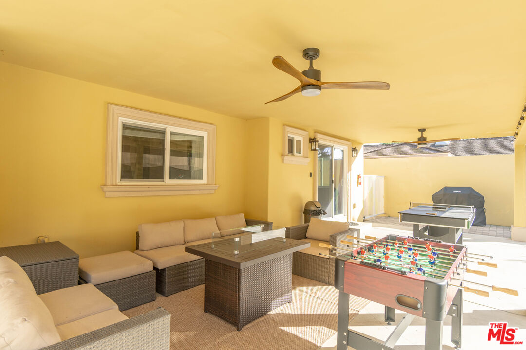 5181 Densmore Avenue Encino, CA 91436 - Photo 67 of 73 a living room with furniture and a floor to ceiling window