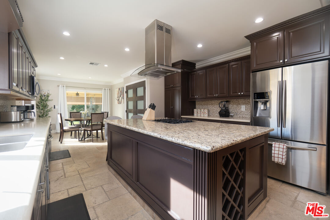 5181 Densmore Avenue Encino, CA 91436 - Photo 9 of 73 a kitchen with stainless steel appliances granite countertop a refrigerator a sink and a oven