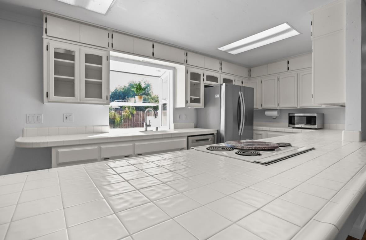 5852 Olive Ranch Road Granite Bay, CA 95746 - Photo 20 of 46 a kitchen with stainless steel appliances kitchen island granite countertop a sink and cabinets