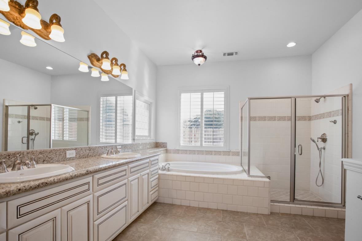 5852 Olive Ranch Road Granite Bay, CA 95746 - Photo 28 of 46 a spacious bathroom with double vanity a mirror a bathtub and next to a window