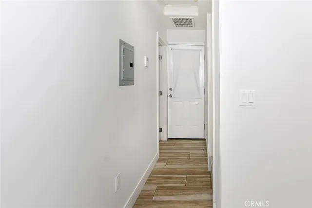 a view of a hallway with wooden floor and entryway