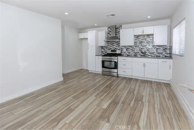 a kitchen with stainless steel appliances a refrigerator and cabinets