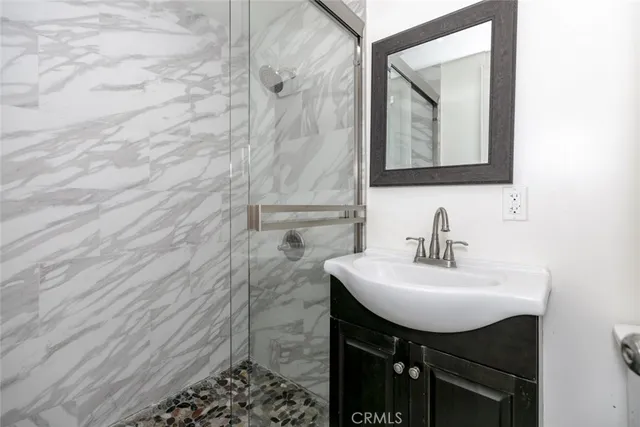 a bathroom with a sink a toilet and mirror