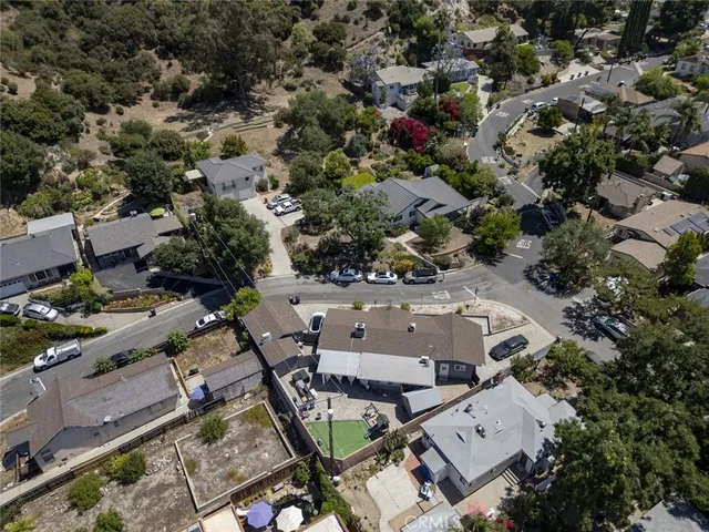 an aerial view of multiple houses with yard