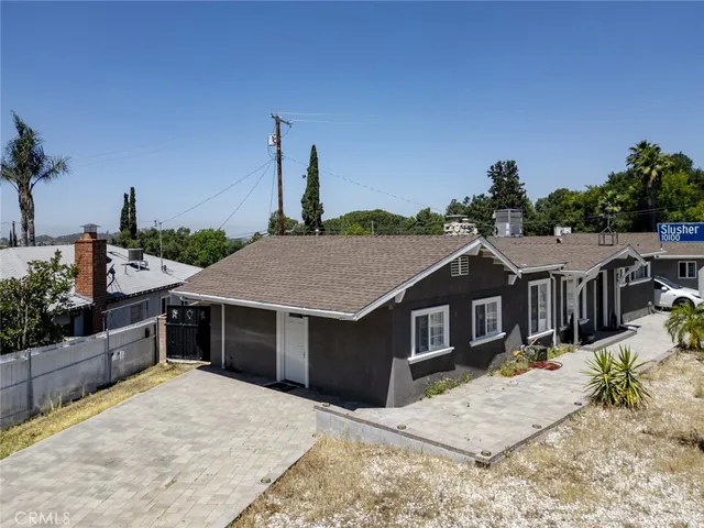 a house with a yard and wooden fence