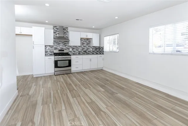 a kitchen with stainless steel appliances a refrigerator and window