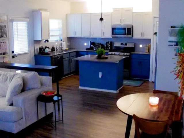a kitchen with granite countertop a stove and a microwave