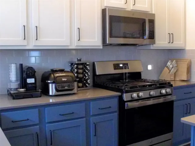 a kitchen with a refrigerator and a table