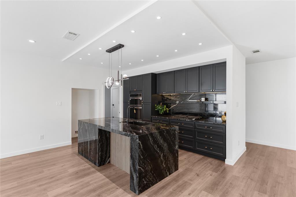 2535 Exline Street Dallas, TX 75215 - Photo 15 of 38 a kitchen with stainless steel appliances a refrigerator and wooden cabinets