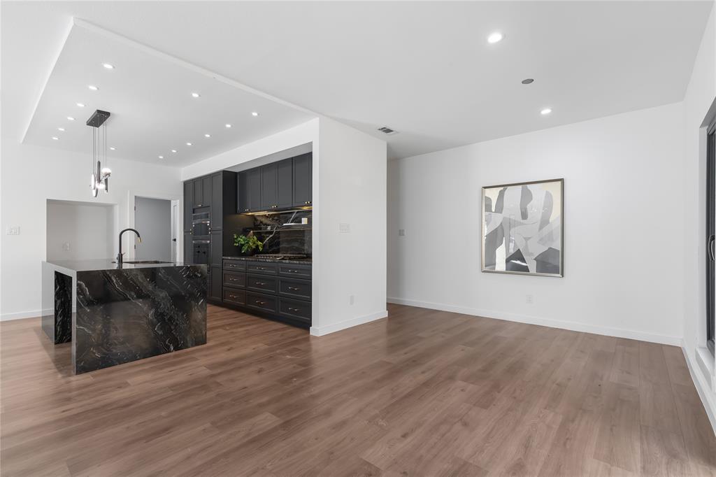 2535 Exline Street Dallas, TX 75215 - Photo 19 of 38 a view of a living room a wooden floor and a ceiling fan