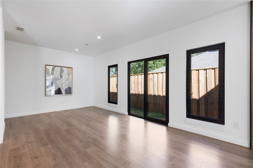 2535 Exline Street Dallas, TX 75215 - Photo 20 of 38 a view of a big room with wooden floor and windows