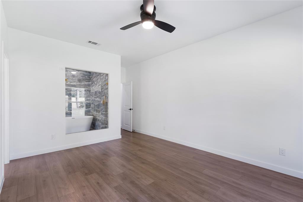 2535 Exline Street Dallas, TX 75215 - Photo 26 of 38 an empty room with wooden floor cabinet and windows